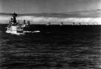 Of the eleven battleships, all making a starboard turn while steaming in column, USS Maryland is at left, closest to the camera